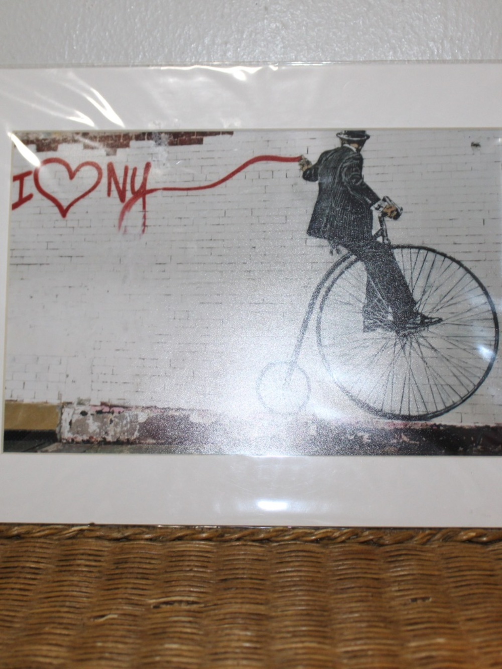 Walker's signature "Vandal" character wearing a bowler hat and riding a bike.